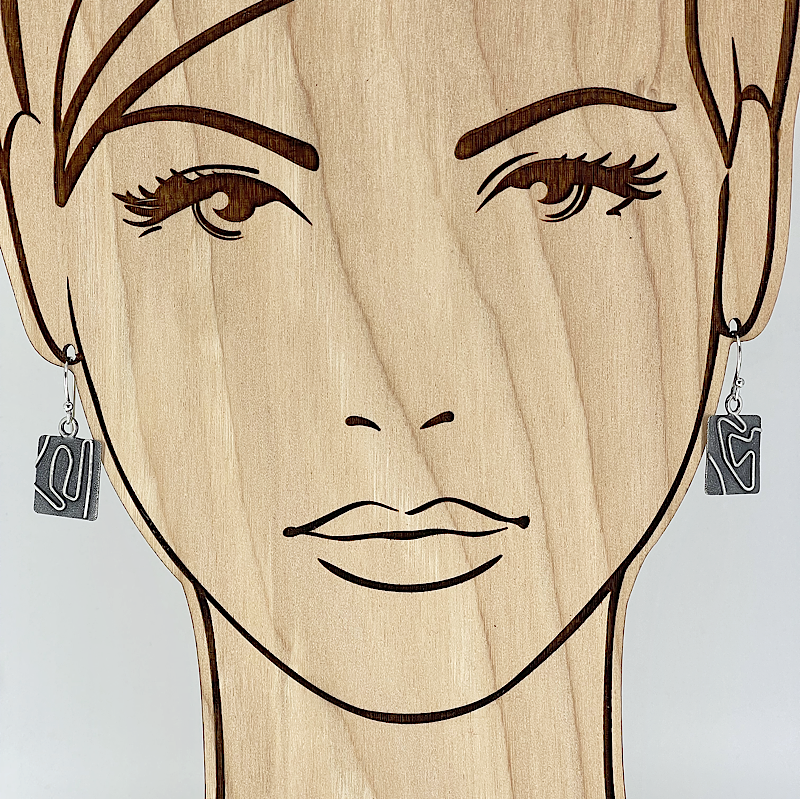 Unique sterling silver earrings on a model