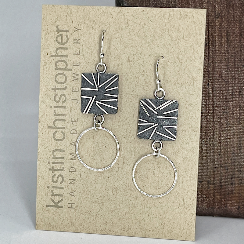 Unique sterling silver earrings with silver hoops on a Kristin Christopher card