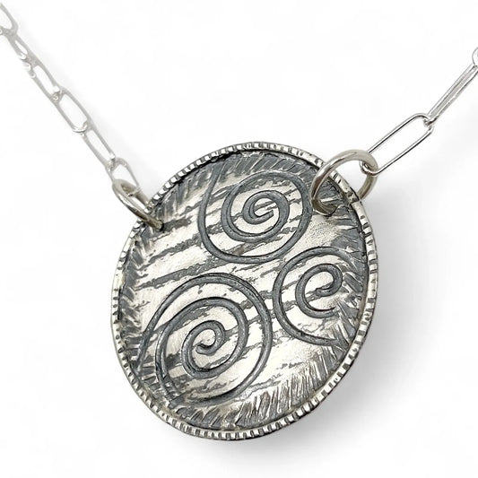 Angled view of Sterling Silver Spiral Necklace by Kristin Christopher